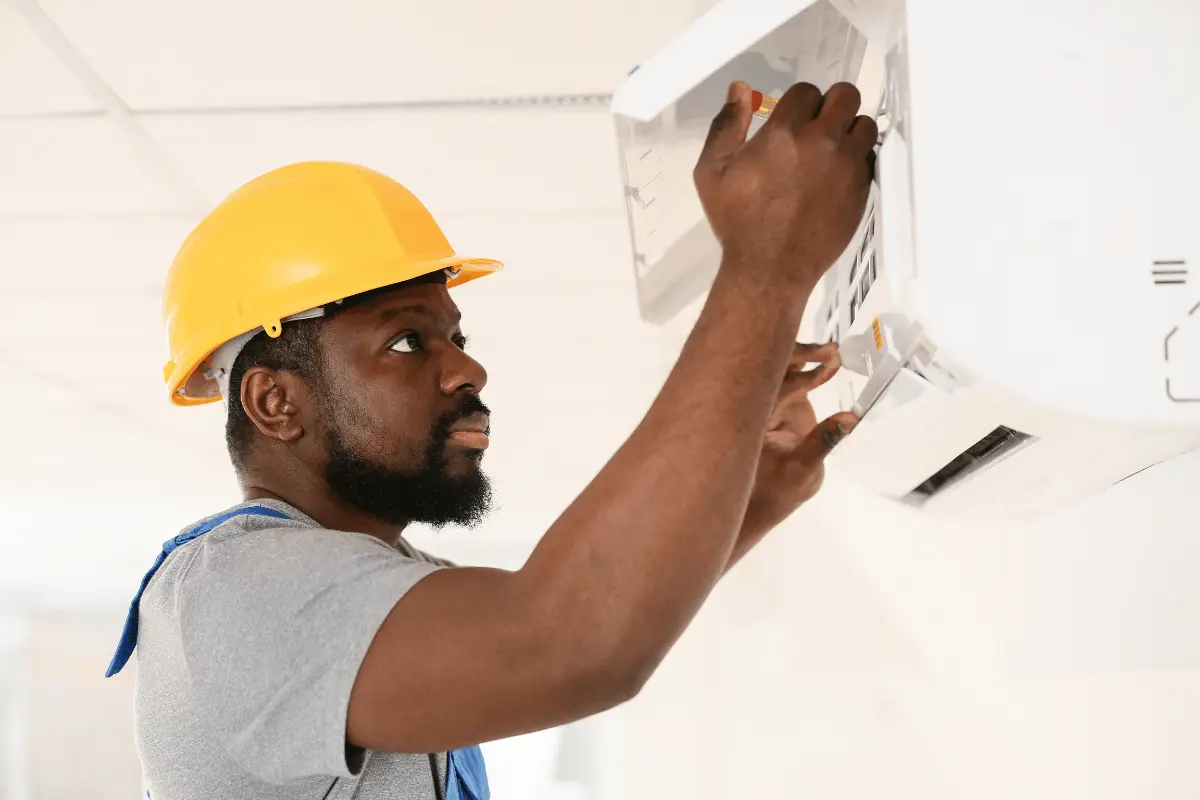 Technician servicing an air conditioner
